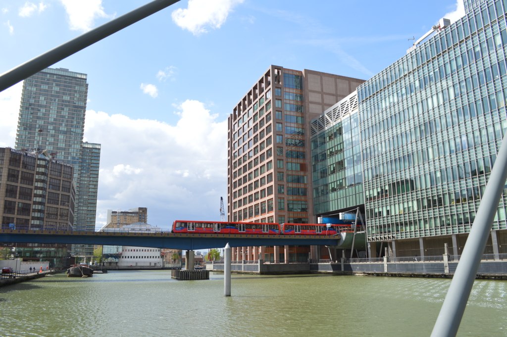 A photo of a light rail train on elevated tracks over water.